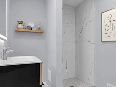 Modern bathroom with floating black vanity, marble shower wall, and decorative shelf in Malvern, PA
