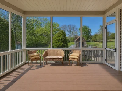 A neutral-toned enclosed deck with wicker furniture in Newtown Square, PA
