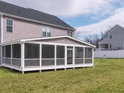 A modern deck with white rails and a screen enclosure in Paoli, PA